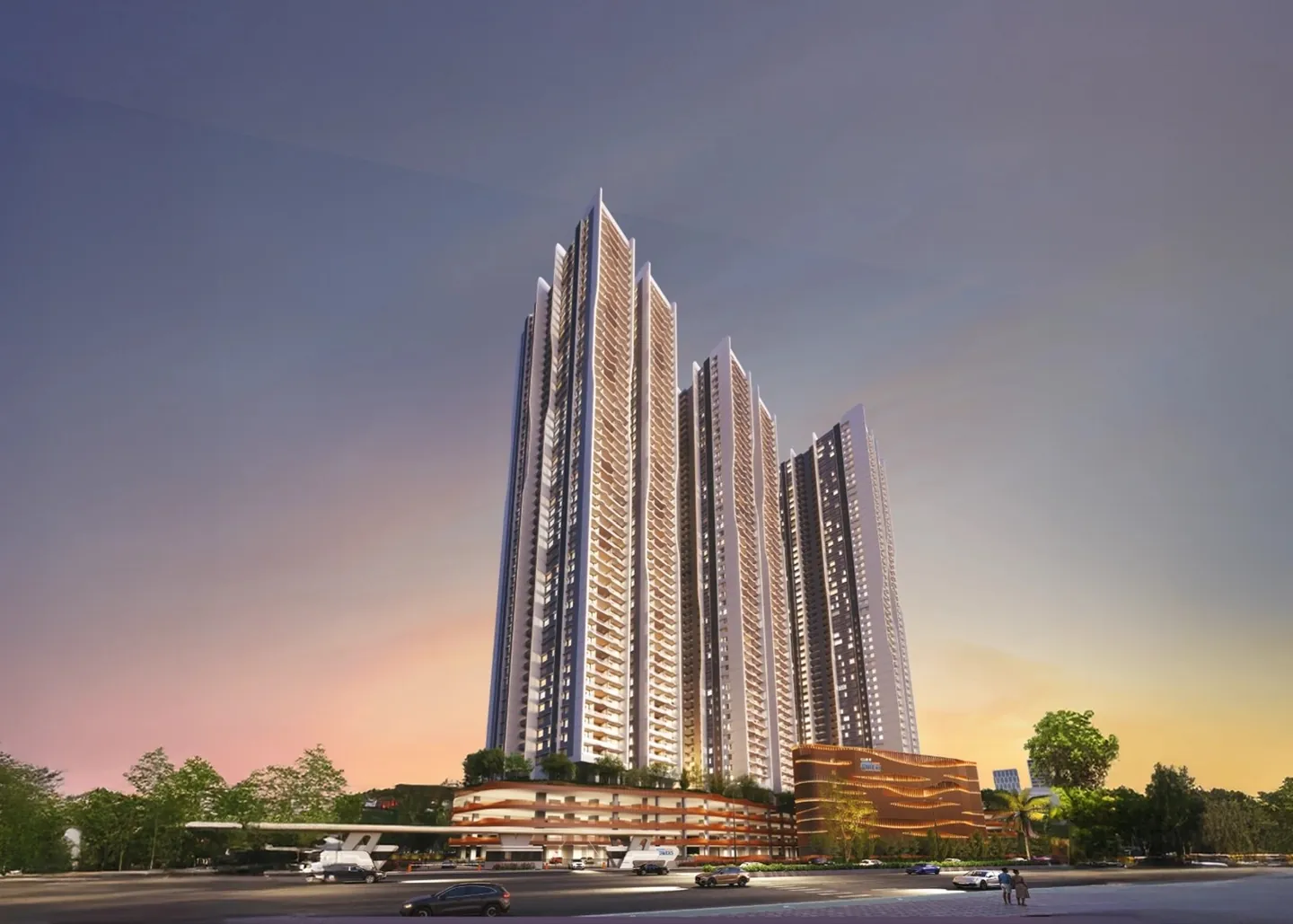 Tall white apartment towers rising above a landscaped podium at sunset at Aparna Sarovar Towers